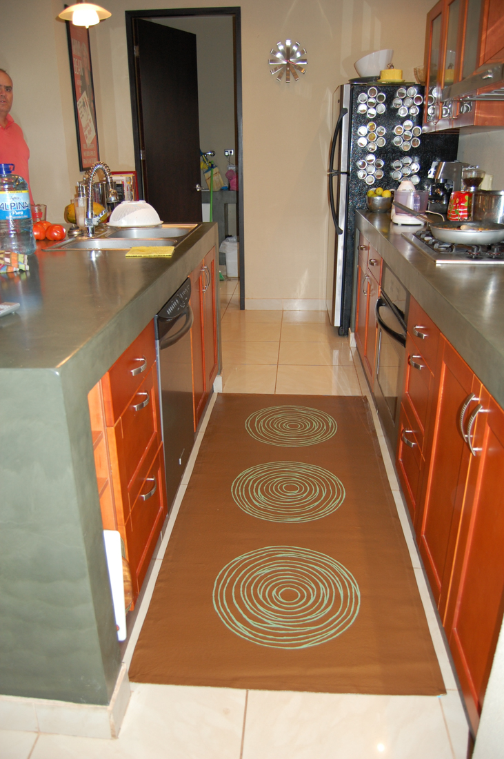 Matching copper toned painted canvas kitchen rug